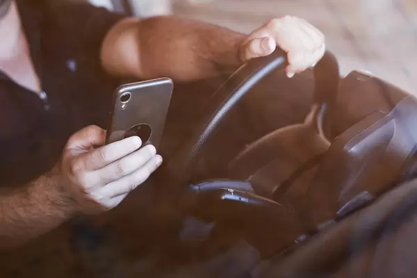 10. A man driving and texting on mobile smartphone.jpg