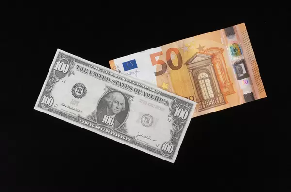 100 Dollar and 50 Euros banknote on black background