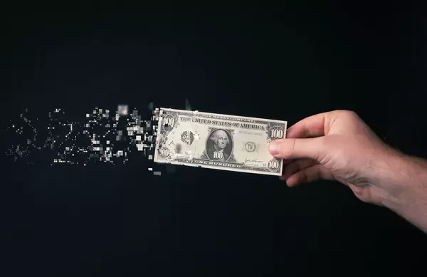 100 dollar bill tearing apart