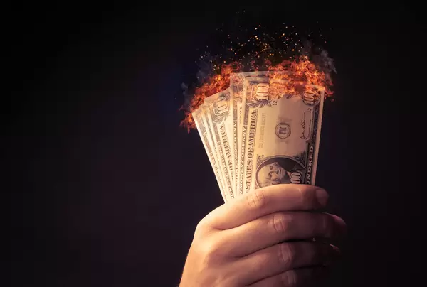 100 dollar bills on fire