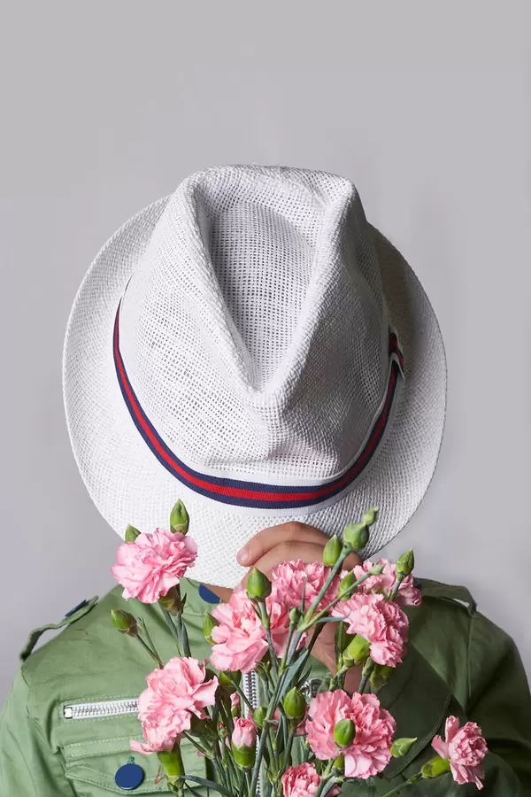 12. A schoolboy holding a bunch of fresh rose flowers.jpg