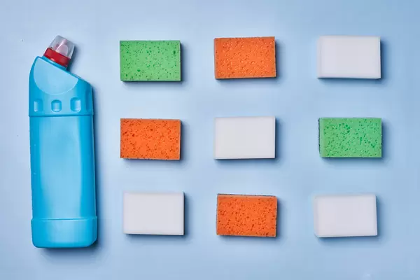 18. Cleaning spray bottle and sponges on blue background. Flat lay, top view. Cleaning services concept.jpg