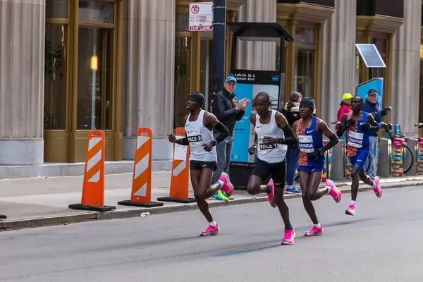 2019 Chicago Marathon winner, Kenyan Lawrence Cherono and his fellow national Dickson Chumba, who ranked 7th, preceded by pacers during the race in Downtown Chicago