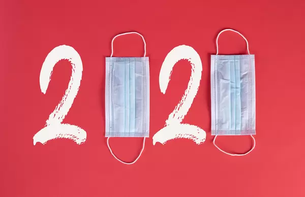 2020 text made from medical face masks on red background
