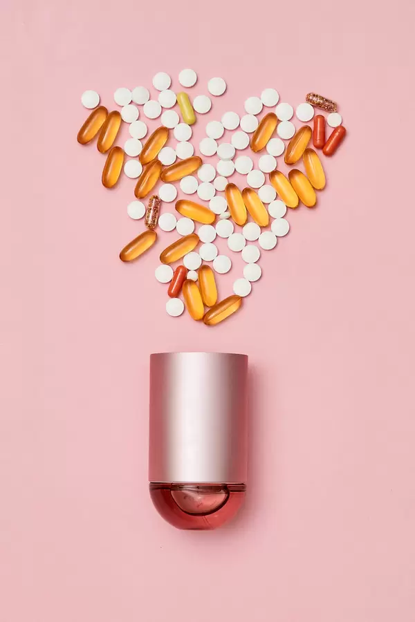 30. Pile of medical drugs and container on bright color background