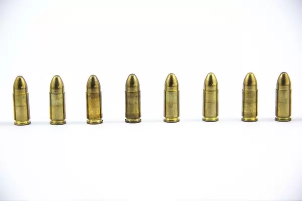 9mm bullets standing next to each other on white Background