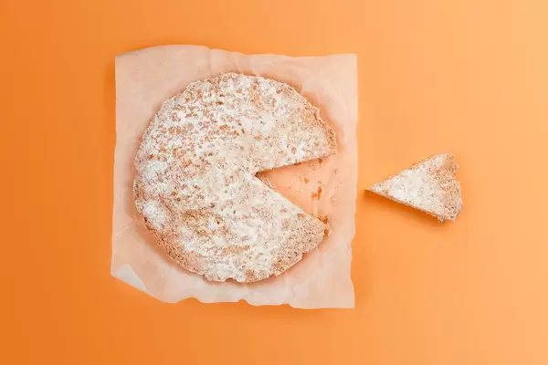 A big cottage cheese pie dessert and a sliced piece