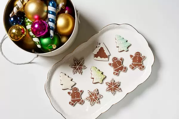 A big plate of sweet Xmas festive cookies and box of Christmas decorations