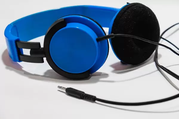 A blue headphones on white surface.jpg