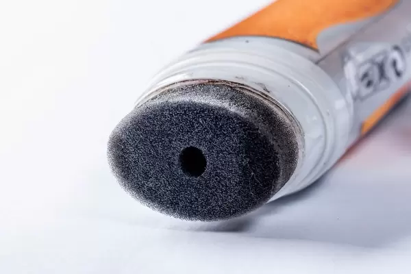 A bottle of black Shoe Polish with a special sponge