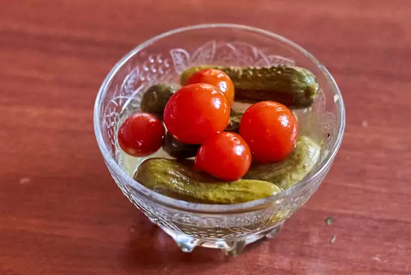 A bowl of delicious pickled cucumbers and tomatoes