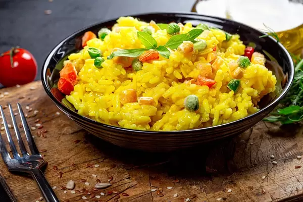 A bowl of rice and vegetables on an old kitchen board (Flip 2019)