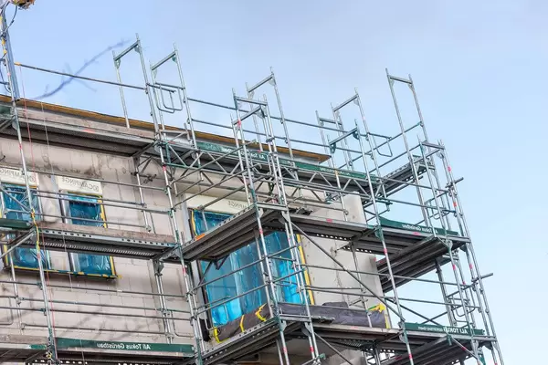 A building with scaffolding against the blue sky