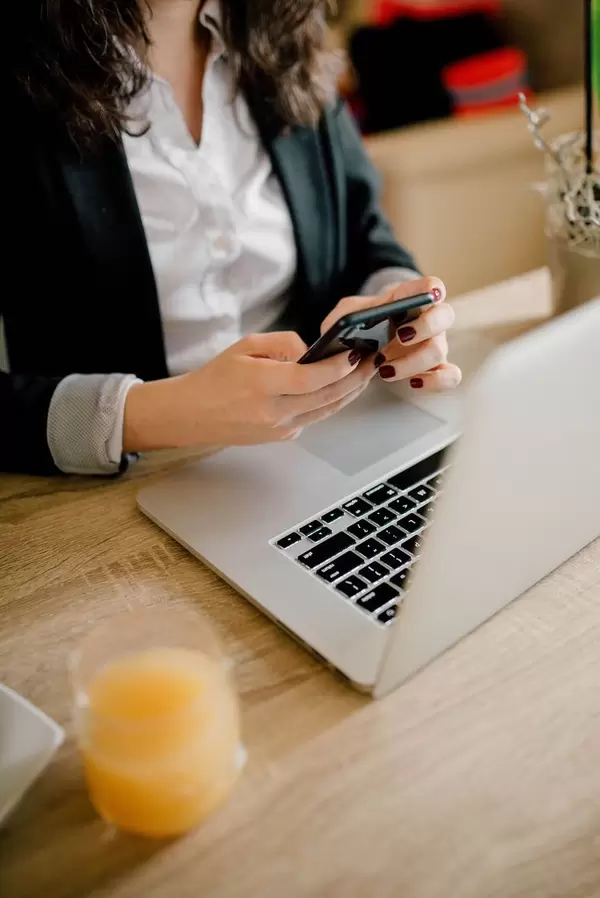 A business woman typing a text message on her mobile phone