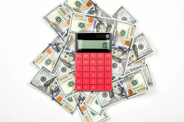 A calculator placed on the pile of US dollars