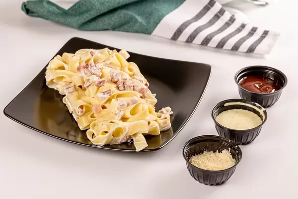 A classic recipe for carbonara pasta on table with ingredients