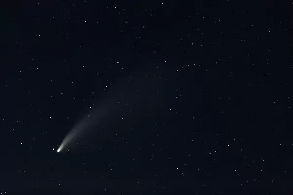 A comet passing near the earth with a glowing tail