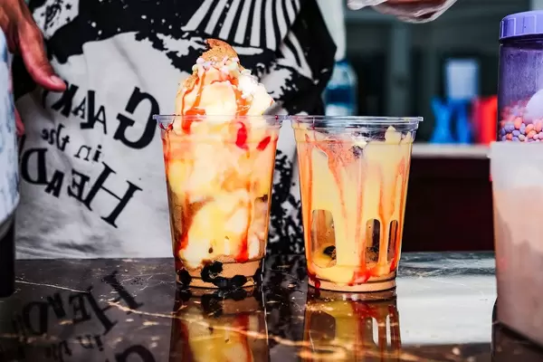 A cup filled with mango flavored shake (Flip 2019)