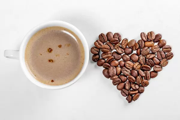 A Cup of coffee and a heart made of coffee beans (Flip 2019)