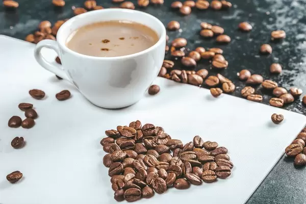 A Cup of fresh coffee with coffee beans on the table (Flip 2019)