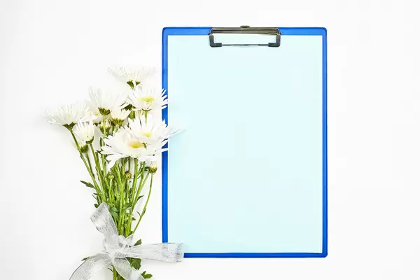 A cute spring flowers bouquet and blank paper with copy space