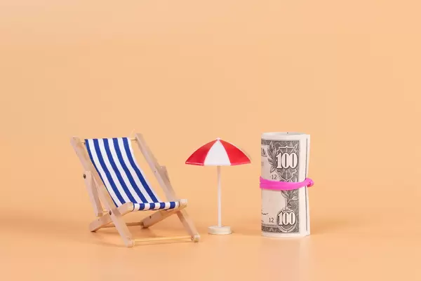 A deck chair, umbrella and money roll