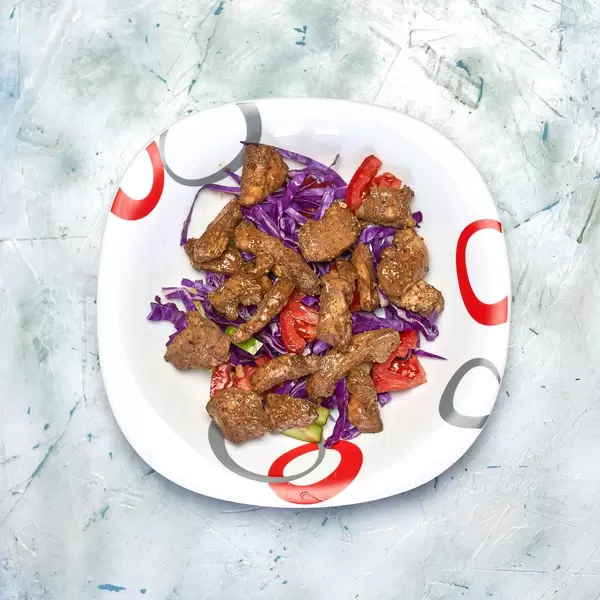 A delicious meal for sportsmen. Meat salad with chicken fillet and fresh vegetables on the plate