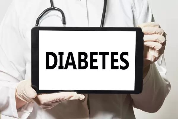 A doctor holding a tablet device with Diabetes word
