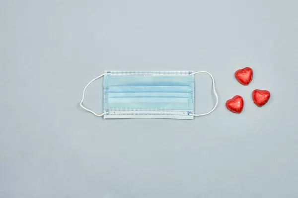 A face mask with three heart-shaped chocolates