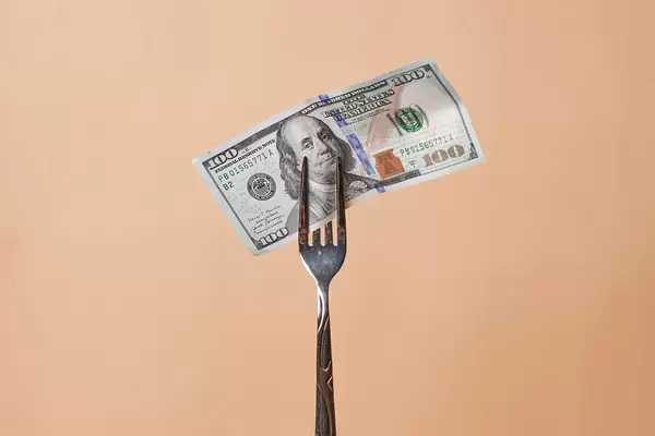 A fork with hundred dollar bill