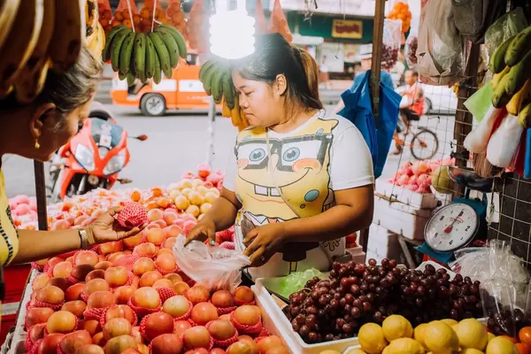 A fruit vendor selling at a sidewalk in Bacolod City