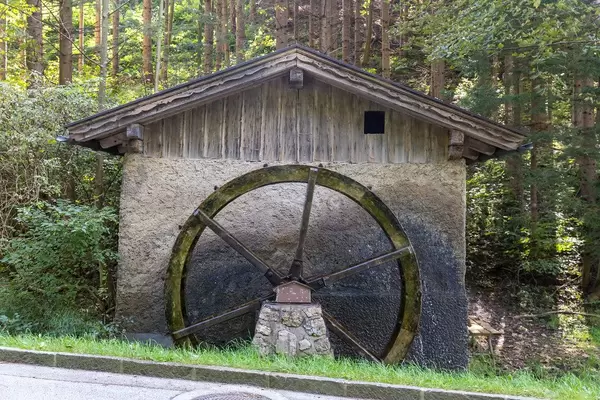 A functioning watermill with water wheel at the roadside in Tyrol (Austria)