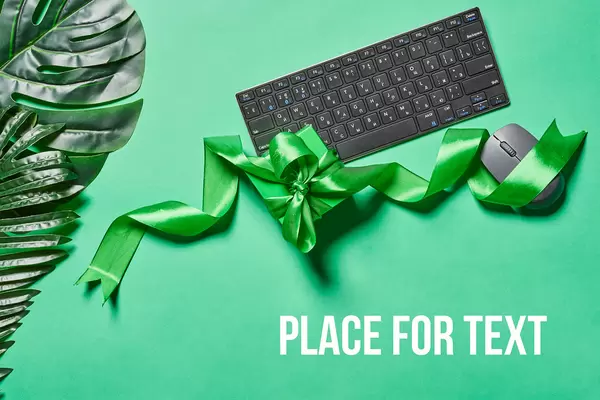 A giftbox and computer keyboard with mouse