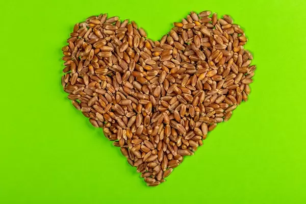 A grain of wheat in shape of heart on green background (Flip 2019)