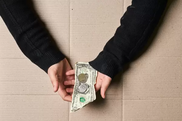 A homeless person begging for money