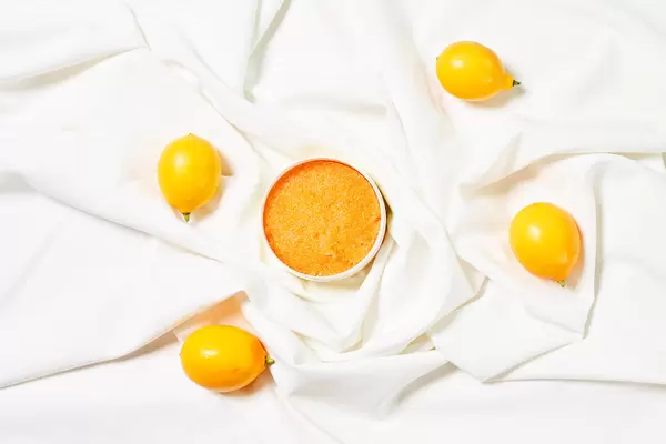 A jar of homemade lemon facial mask or exfoliating sugar scrub