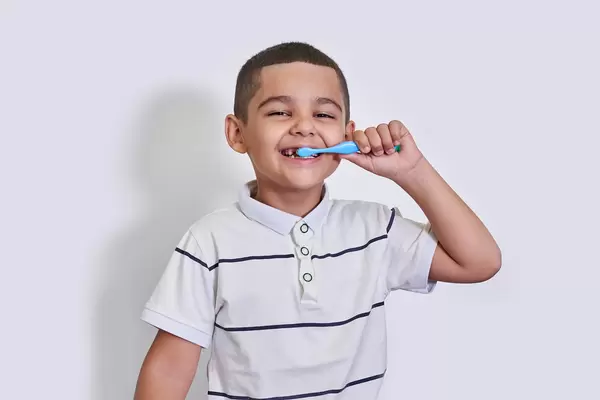 A little mixed-race boy brushing his teeth