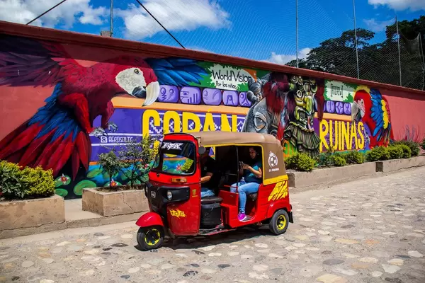 A Local Taxi Passing Through a Graffiti Painting