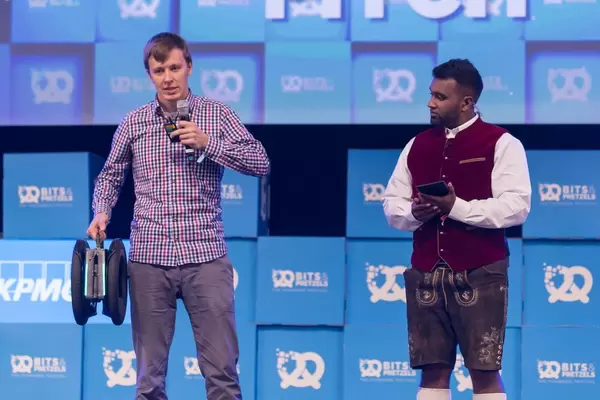 A man gives a speech next to Dan Ram