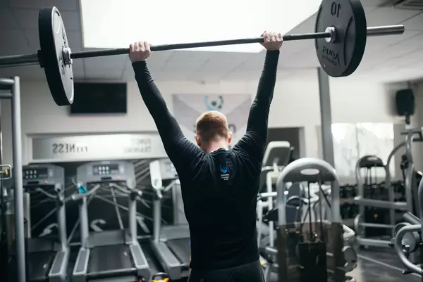 A man lifting a weight at the gym   Flip 2019