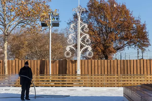 A man prepares the ice skating surface