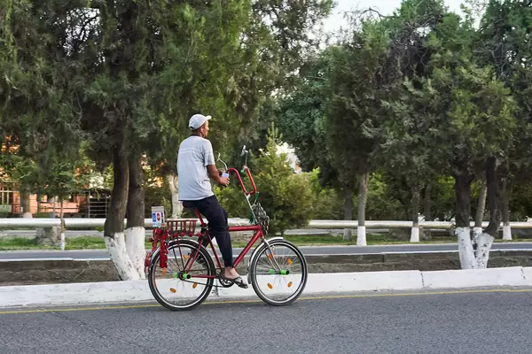 A man riding a unique bike