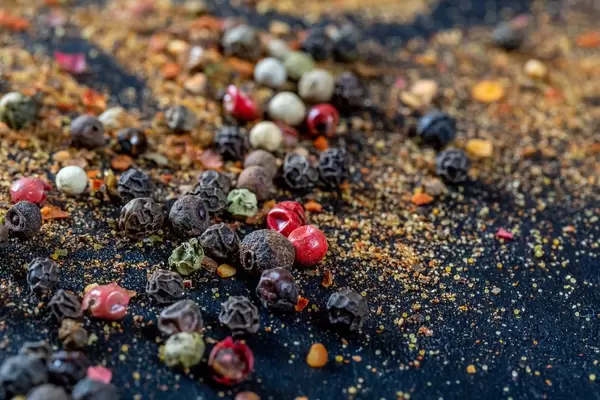 A mix of colorful peppers on a dark background