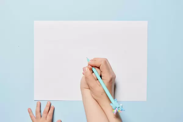 A mother teaching her baby drawing