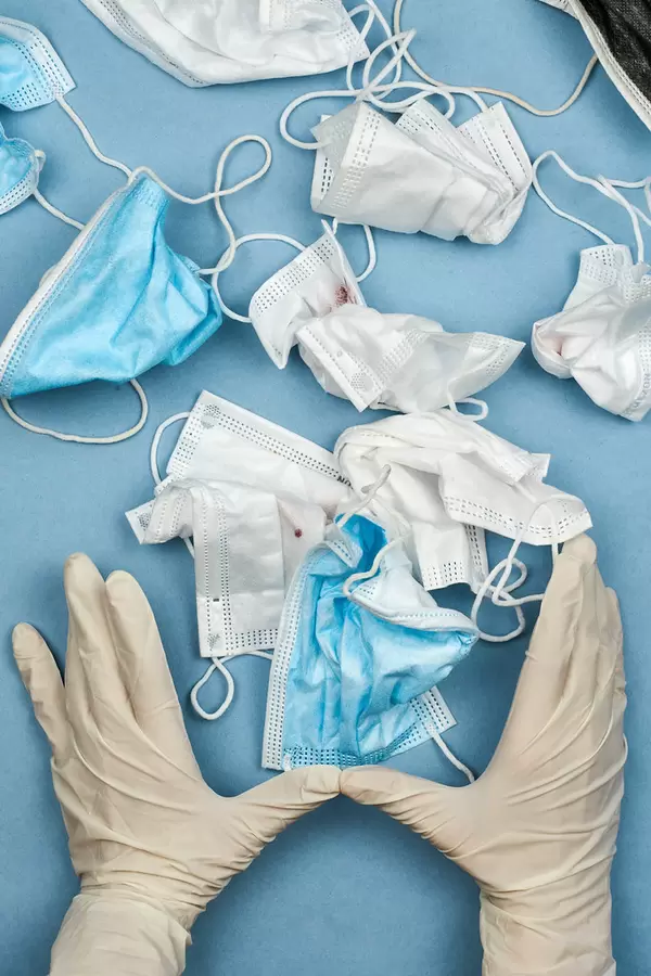 A nurse collecting used face masks