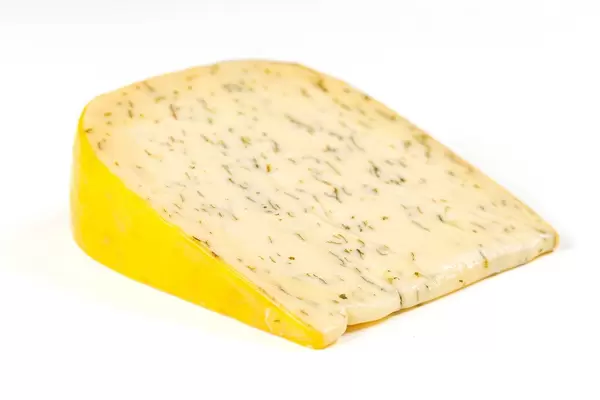 A piece of Dutch cheese with herbs and garlic on a white background (Flip 2020)