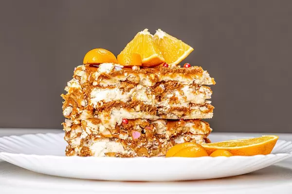 A piece of Kiev cake with condensed milk, nuts and citrus fruits (Flip 2020)