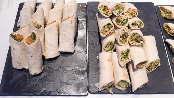 A pile of wraps with different ingredients