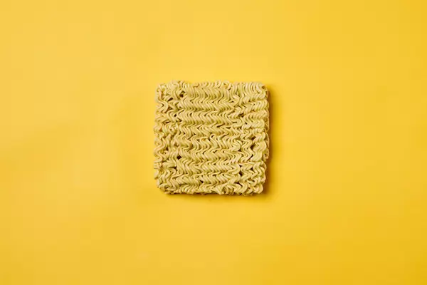 A quick cooking instant noodle on yellow