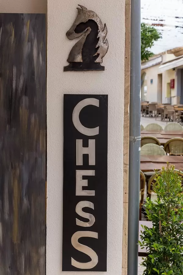 A "Chess" sign and the symbol of a horse on a building in Alcudía, Majorca
